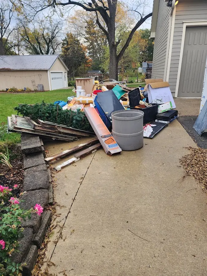 Dumpster being loaded with debris for 3 Yard Dumpster Rental in Monticello